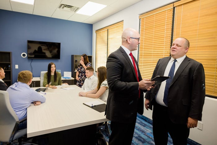 Attorneys Joshua Ernst and Thomas Brown discussing a case